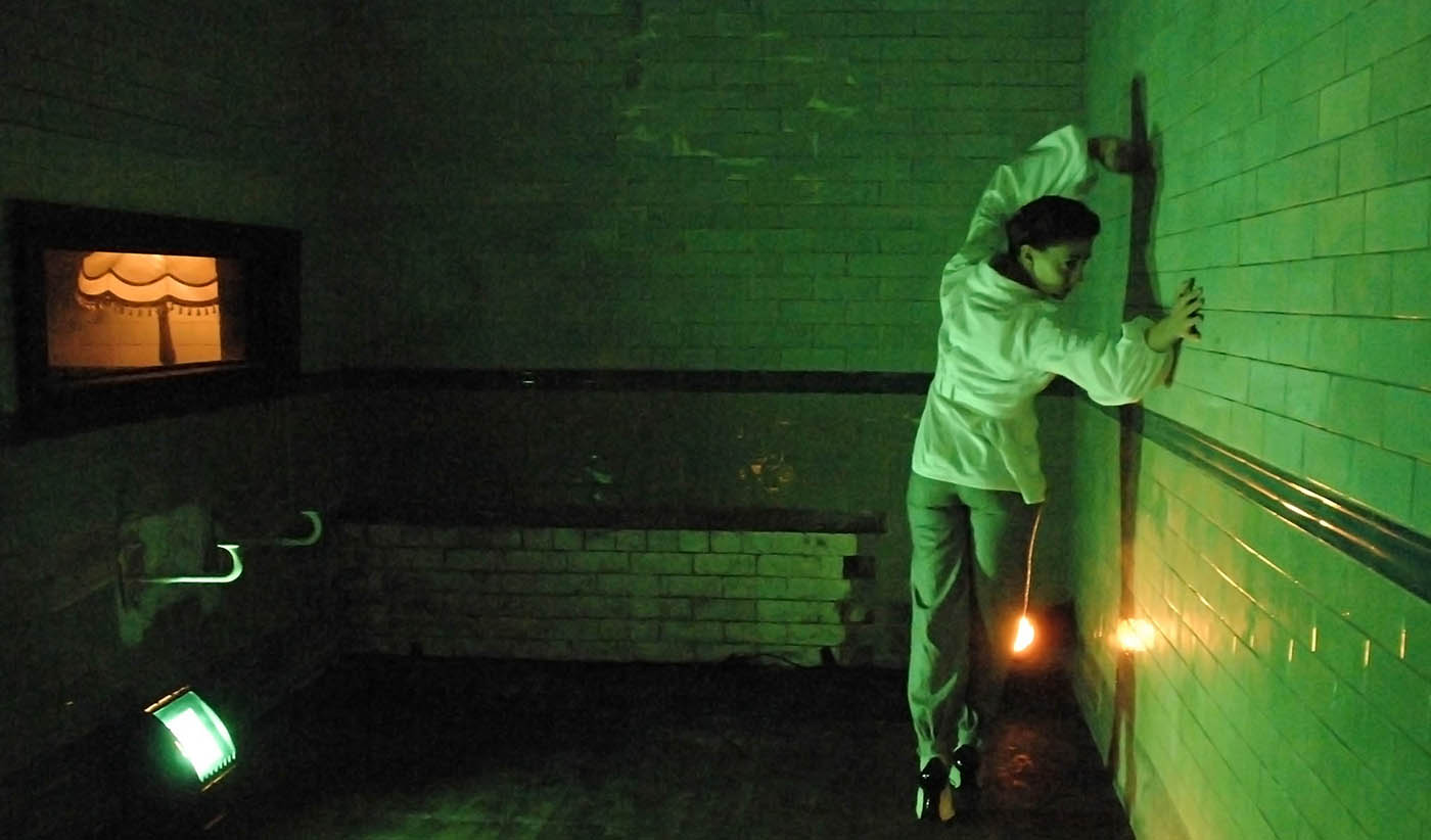 Washroom 2: Dancer stuck to the tiled wall, lit in green. She can move but without ever coming off the tiles.